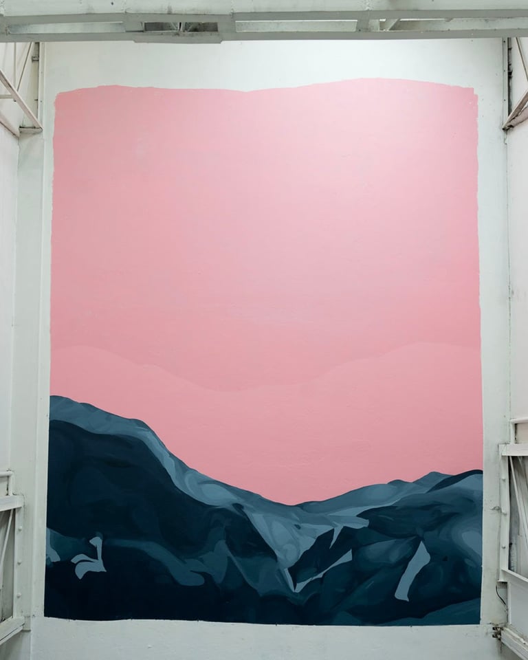 Minimalist landscape painting with silhouetted dark mountains against a pink sky on white gallery wall